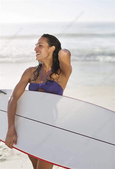 Smiling Woman Holding Surfboard On Beach Stock Image F Science Photo Library