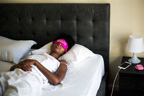 Babe Ethnic Lady In Bright Pink Sleeping Mask On Comfortable Bed In Hotel Room Del