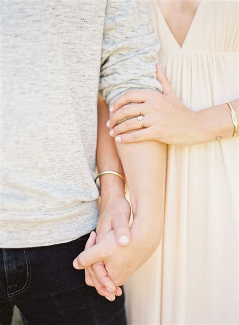 An Image Of Two People Holding Hands With The Caption Engagement