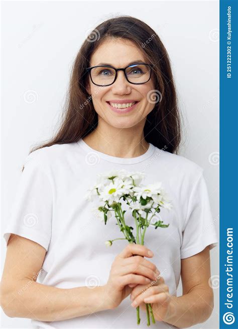 Portrait Of A Beautiful Pleasantly Smiling Woman With Long Dark Hair Wearing Glasses And