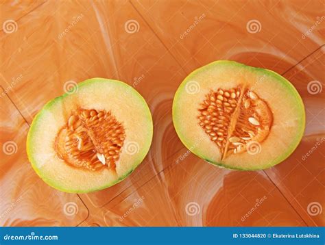 Orange Cut Melon With Seeds Inside Two Halves Of A Beautiful Me Stock