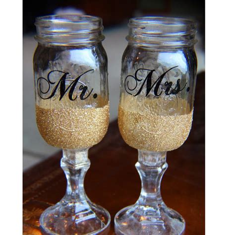 Two Wine Glasses With The Word Mr And Mrs Painted On Them Sitting Next