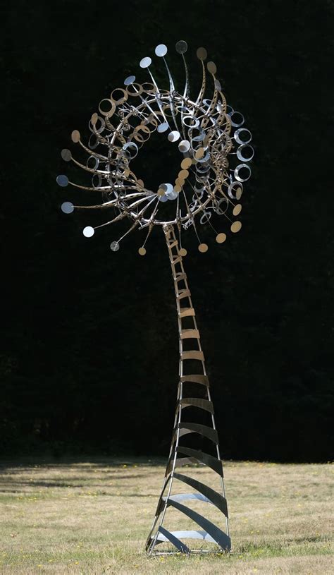 A Tall Metal Sculpture In The Middle Of A Field