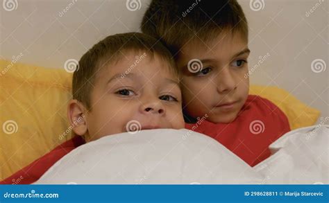 Adorable Siblings Huging Each Other In The Bed Brothers Cuddling In