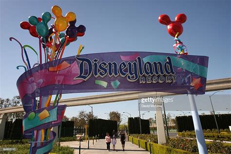 Pedestrians Walk Near The Entrance To Disneyland Resort On February