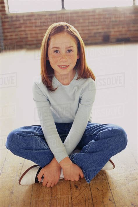 Cute Young Girl Sitting Cross Legged Stock Photo Dissolve