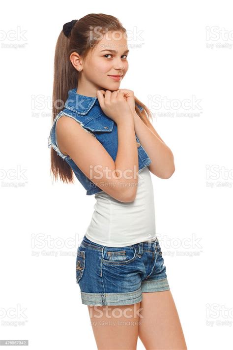 Stylish Teen Girl In A Jeans Vest And Denim Shorts Stock Photo More