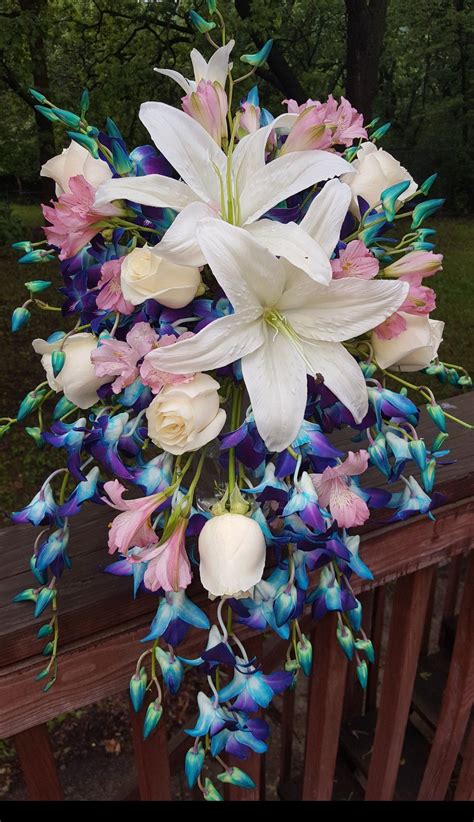 cascading bouquet of fresh blue purple blue galaxy dendrobium orchids pink alstromeria