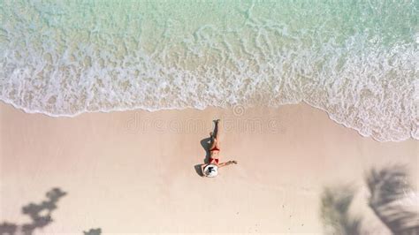 Top View Of Woman In Red Bikini And Relaxation As Lying On Sand During