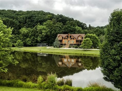 Beautiful House On Lots Of Land With A Lake And Trees Stock Photo