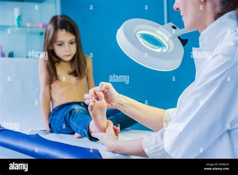 Doctor Examining Girl S Foot Photo Stock Alamy