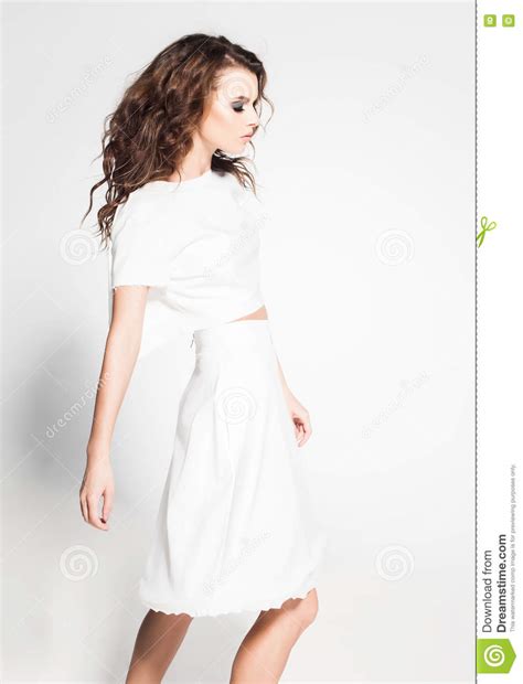 Beautiful Woman Model Posing In White Dress In The Studio Stock Photo