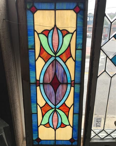 Two Stained Glass Windows Sitting Next To Each Other