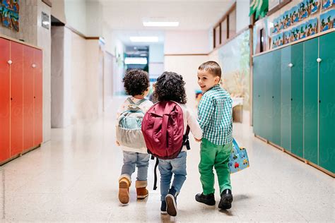 Happy Kids Walking In School Corridor By Sergio Marcos