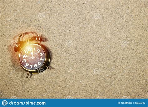 Alarm Showing Twelve O`clock On Sand Good Bye Summer Concept Or