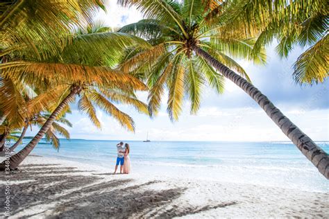Romantic Couple In Love Hugging Kissing And Running On The Sandy Tropical Caribbean Beach In