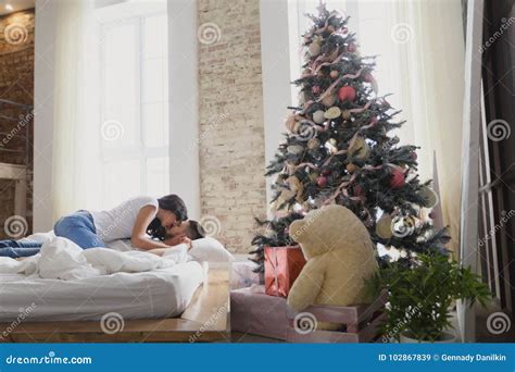Happy Couple Of Lovers Sitting On The Bed Christmas Interior Lovers