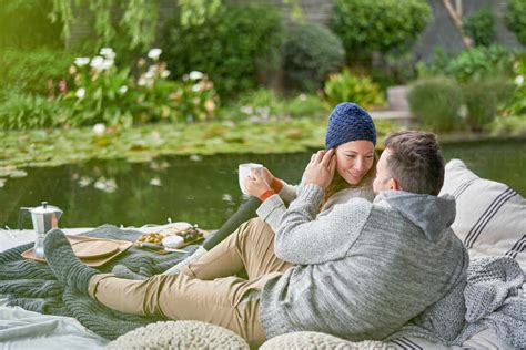 Affectionate Romantic Couple Drinking Coffee On Luxury Patio Stock Photo