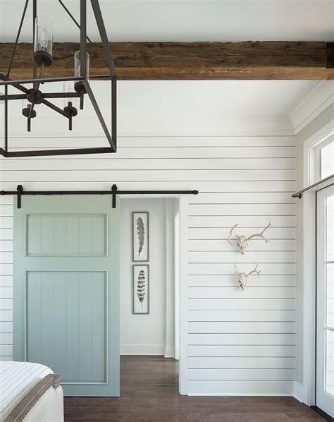Cottage Bedroom Boasts A White Shiplap Wall Fitted With A Blue Shiplap
