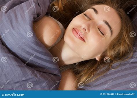 Beautiful Smiling Face Of A Young Woman Sleeping In Bed Close Up Stock