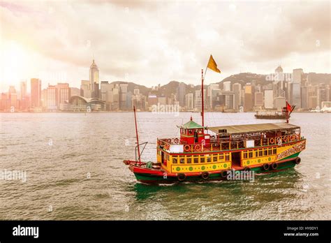 Morning Sunrise Over Hong Kong Skyline With Traditional Chinese Ship