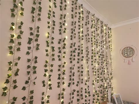 decorate your most boring wall with these curtain fairy lights and some faux ivy vines sage