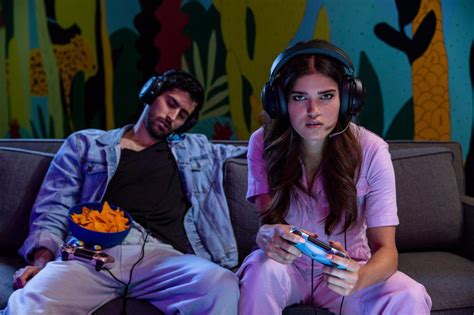 Two Friends Playing Video Games Together With Headsets On Superstock