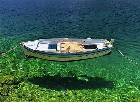 Boat Floats On Crystal Clear Water Photograph By Kostas Pavlis Pixels