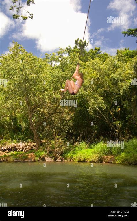 Swinging Over Secret Local Swimming Hole Kipu Falls Kauai Hawaii