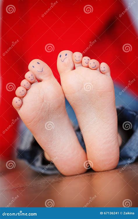 Closeup Picture Of Kid Feet With Smiley Faces Painted Toes Stock Image