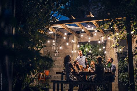 Friends Having Fun At Outdoor Dinner Party By Stocksy Contributor