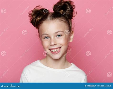 Cute Girl 7-8 Year Old Posing in Studio Over Pink Background Stock