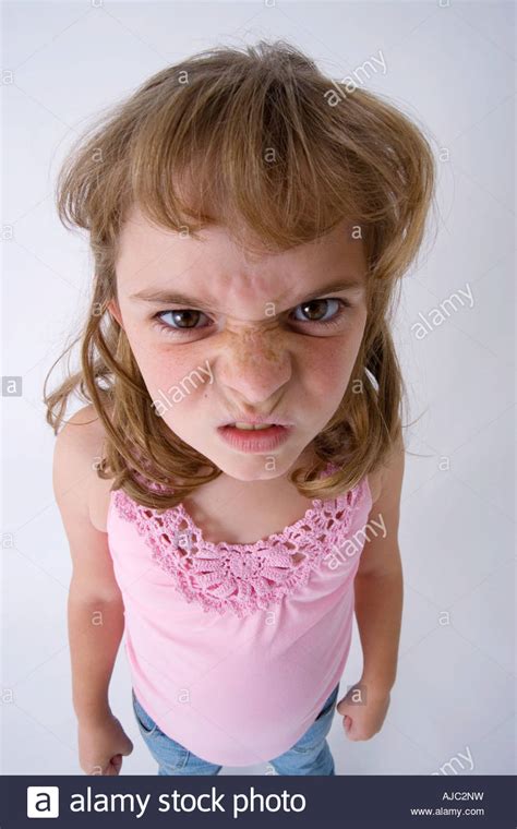 Young Girl Pulling An Angry Face At The Camera Stock Photo