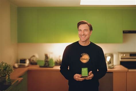 leahlocsin1 attractive dad smiling holding a small plate and wearing a green t shirt