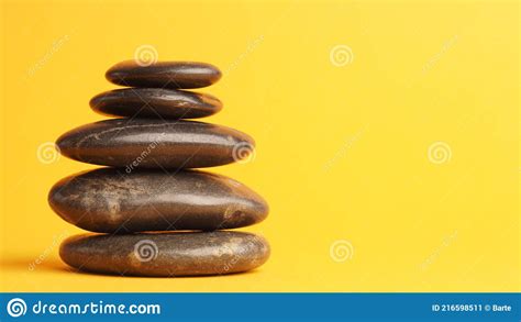 Five Stacked Dark Massage Stones On Yellow Stock Image Image Of Care Relaxation 216598511