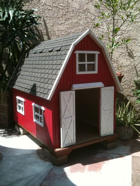 A Red And White Barn Style Dog House