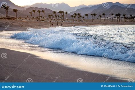 Beautiful Deserted Sandy Beach At Sunset With Sea Waves Stock Image