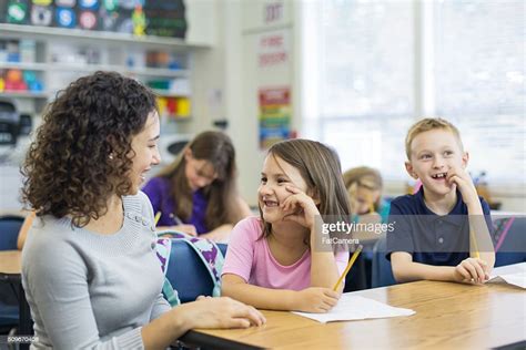 Young Ethnic Teacher Works With Her Elementary School High Res Stock