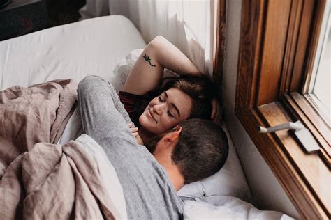 Couple Waking Up In Bed Together by Leah Flores - Bed, Waking up - Stocksy United