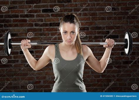 Sweat Fit Woman Lifting Dumbbells On Brick Background Stock Photo