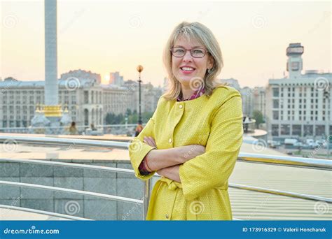 Outdoor Portrait Of Smiling Mature Woman With Folded Hands Stock Image