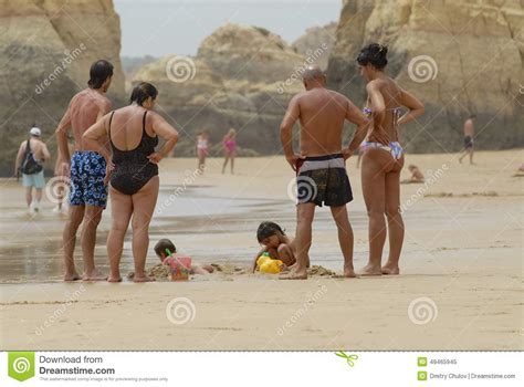 People Watch Kids Playing At The Beach In Portimao