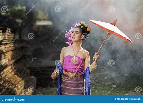 Beautiful Thai Woman Wearing Thai Traditional Clothing With Red Umbrella In Amid The Smoke And
