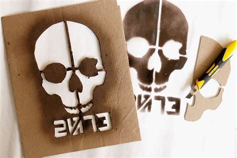 Two Paper Cutouts With The Words E N S And A Skull On Them Are Shown
