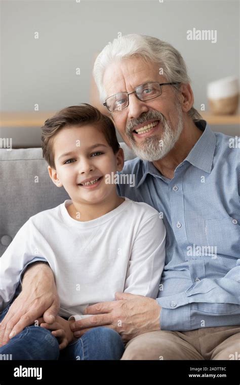 Vertical Image Grey Haired Elderly Grandfather Embraces Little Grandson
