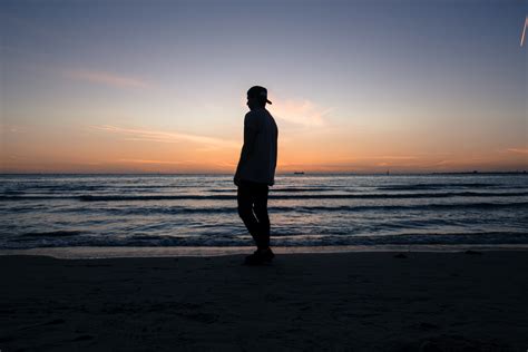 Silhouette Of A Man Standing On St Kilda Beach During A Late Evening Sunset Man Standing Beach