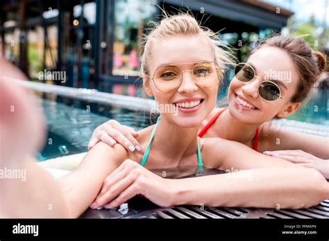 Happy Young Women Taking Selfie In Swimming Pool Point Of Camera View