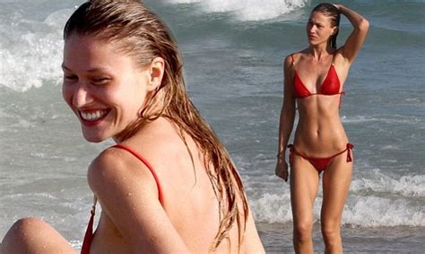 Olga Kent Enjoys A Bond Girl Moment As She Emerges From The Sea In Red
