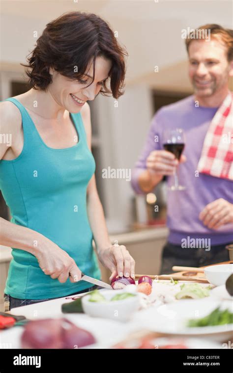 Woman Cooking Dinner In Kitchen Stock Photo Alamy