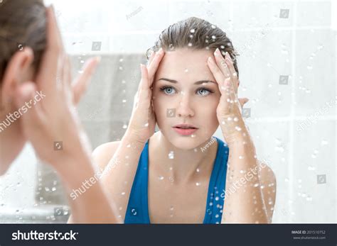 Young Woman Washing Her Face With Clean Water In Bathroom Stock Photo
